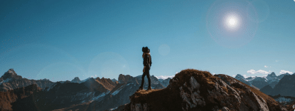 Person standing on top of a mountain